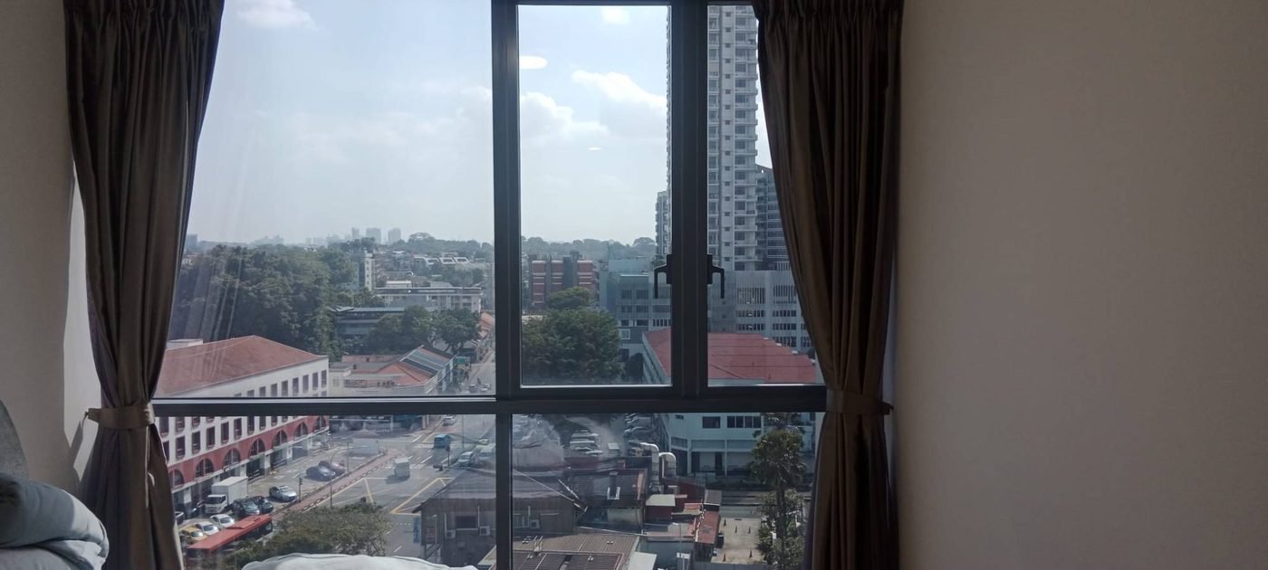 View through a Singapore condo window with Sunolite CF9050 window film, city skyline visible with natural daylight retained